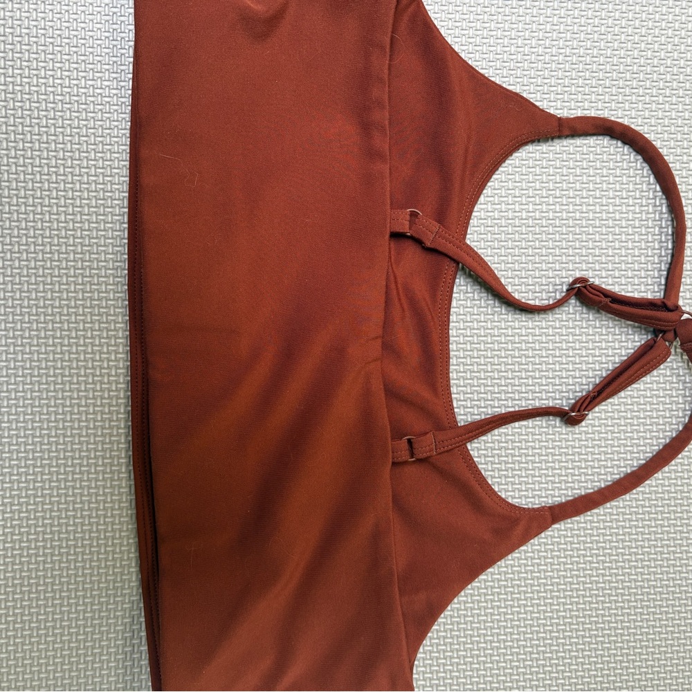 Girlfriend Collective medium rust coloured sports bra
